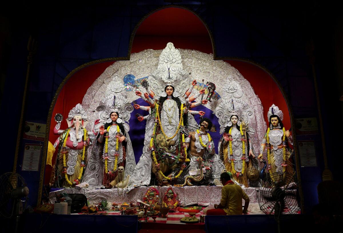 A priest prepares to pray in front of an idol of the Hindu goddess Durga placed on an altar inside a pandal marking Durga Puja festival celebrations, in Kolkata, India, September 29, 2025.