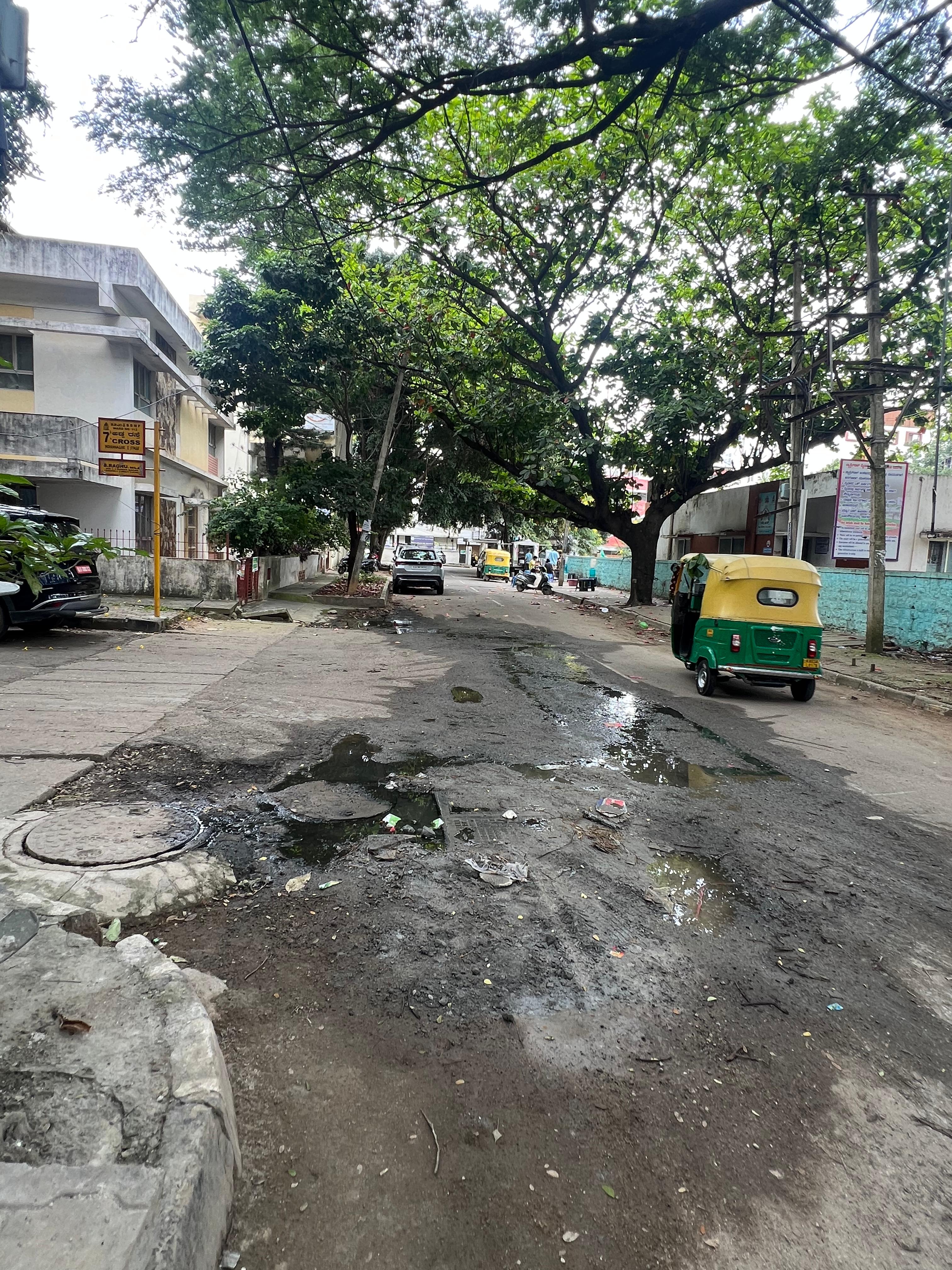 Overflowing drains near 7th Cross in 1st Stage have worsened the asphalted road. 