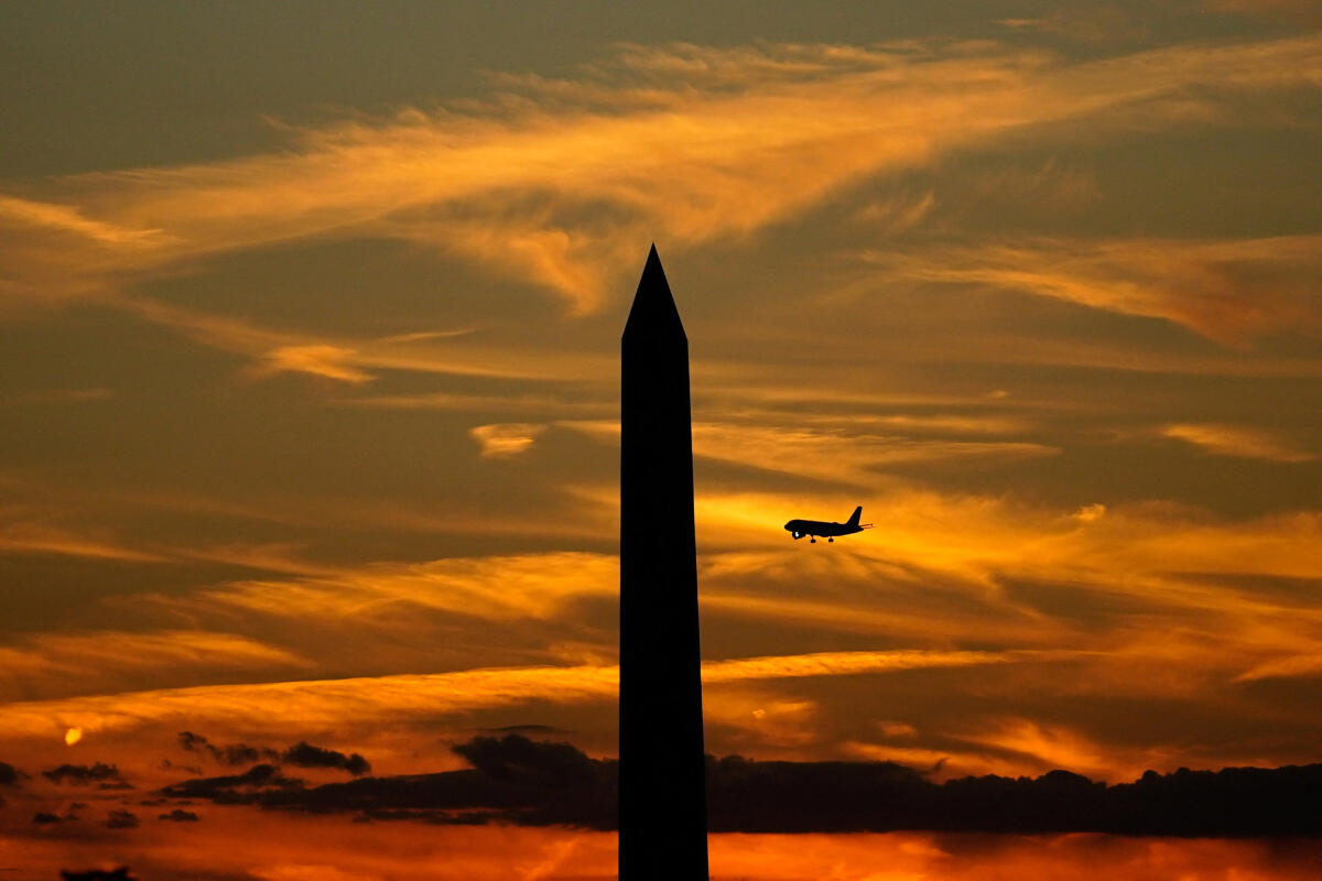 A comercial airline flies past the Washington Monument, following a partial government shutdown in Washington, DC, US