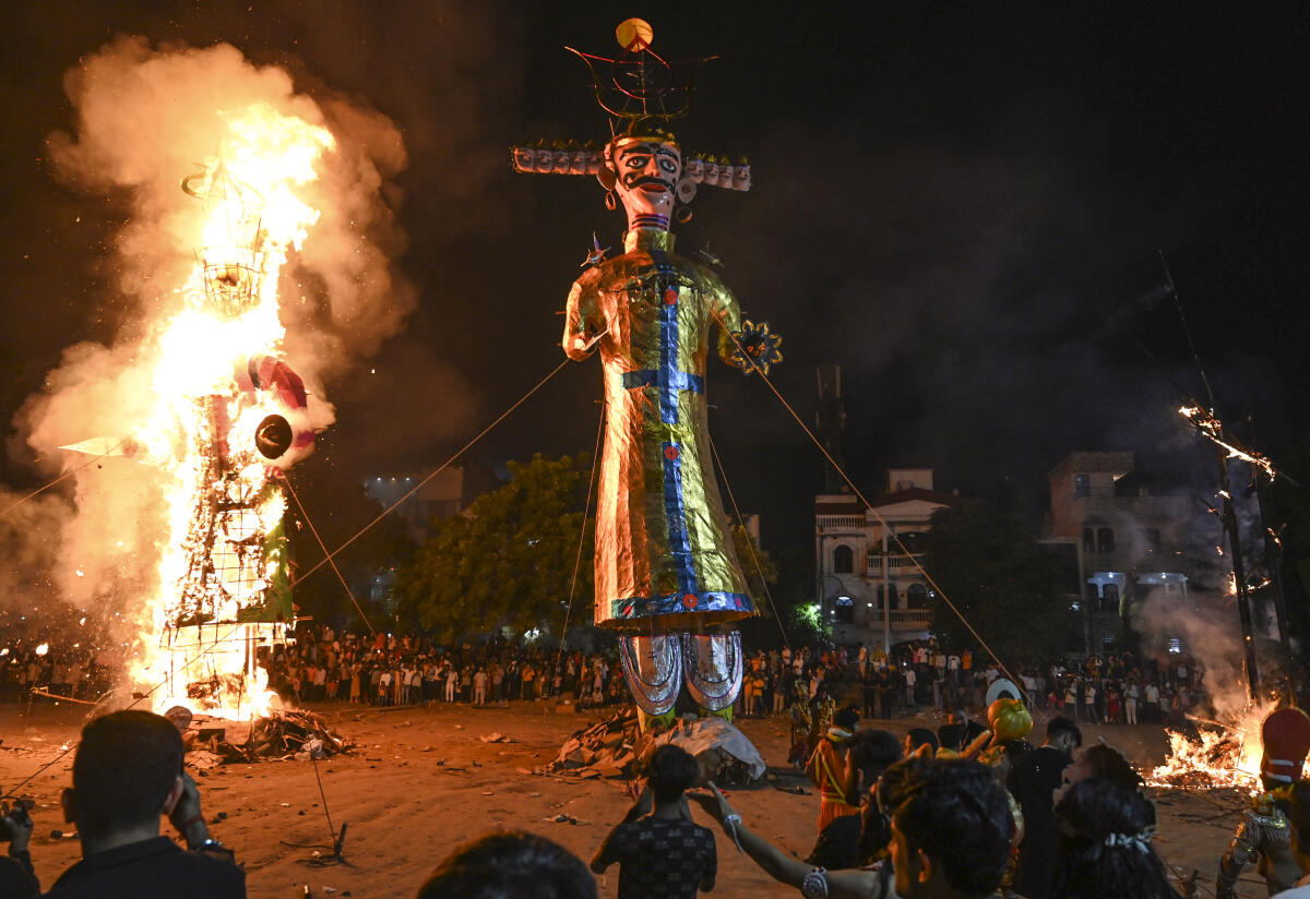 Effigies of Ravana’s brother ‘Kumbhakarna’ and son ‘Meghnath’ burn in flames during the ‘Dussehra’ festival celebrations, in Gurugram, Haryana