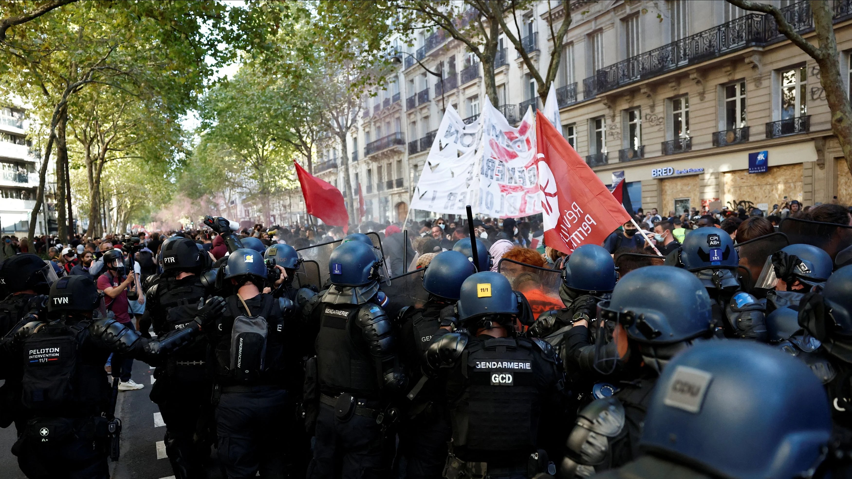 French gendarmes face with protesters during clashes at a demonstration in Paris as part of a day of nationwide strikes and protests against the government and cuts in the next budget, with supporters of the "Bloquons Tout" (Let's Block Everything) movement, France, September 18, 2025. 