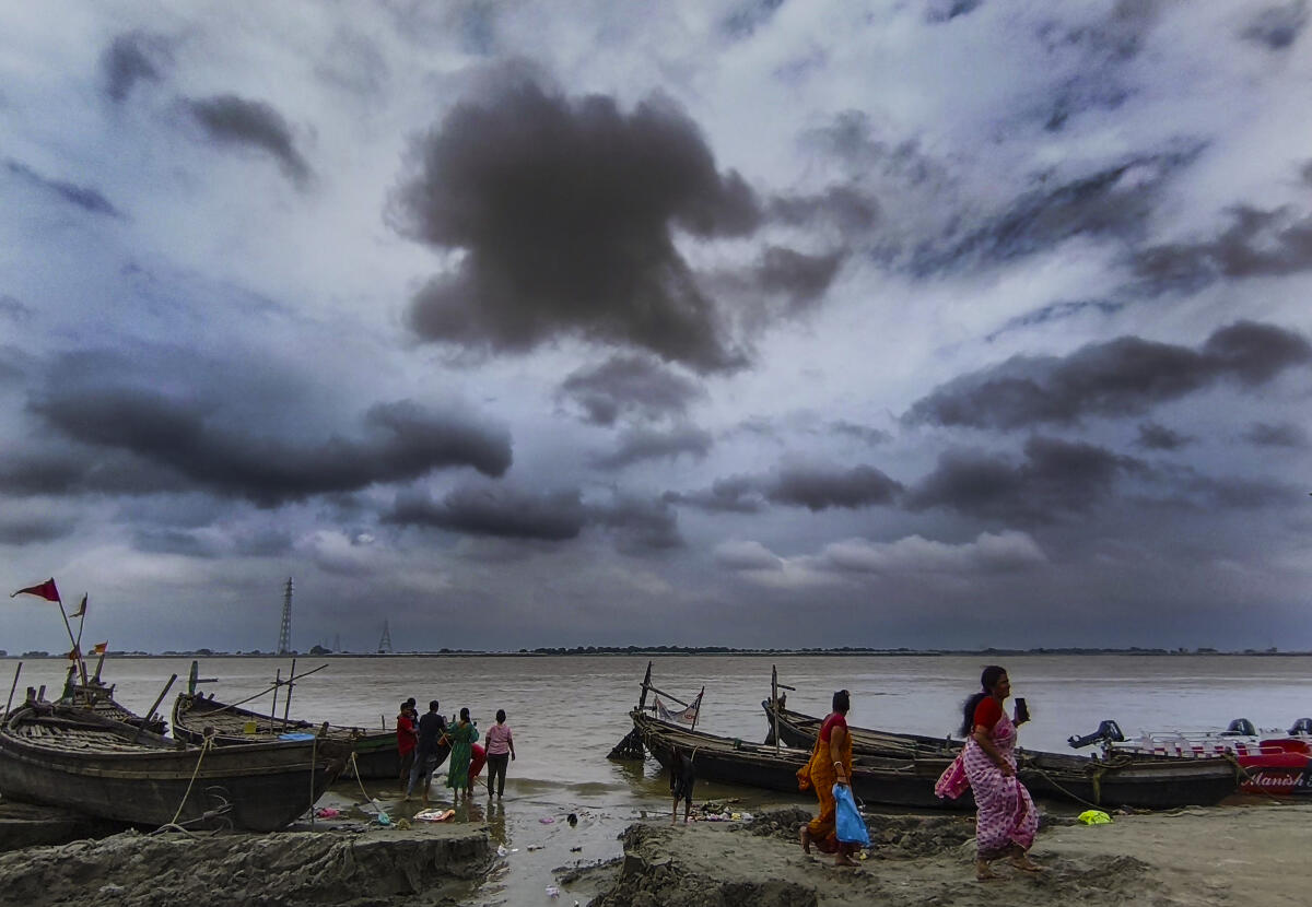 Boats anchored near the shore on a cloudy day, in Patna