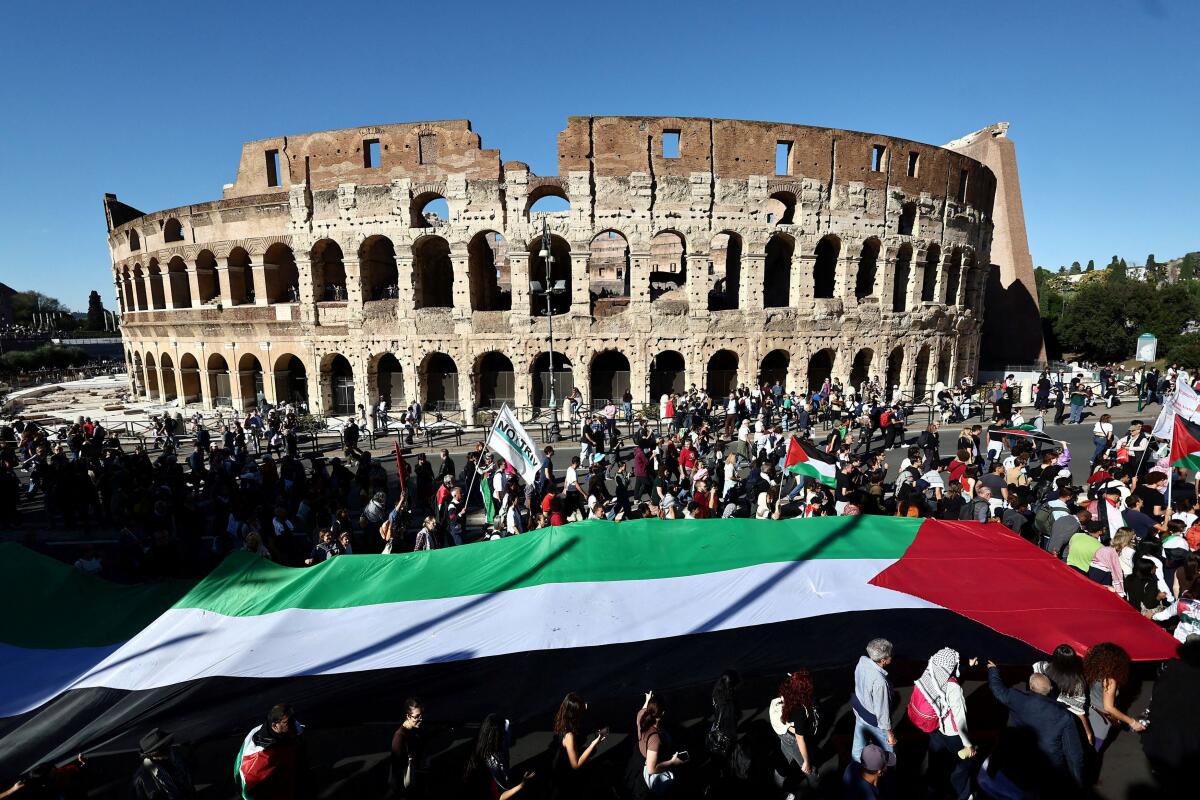 Pro-Palestinian demonstrators take part in a national protest for Gaza, outside the Colosseum in Rome, Italy