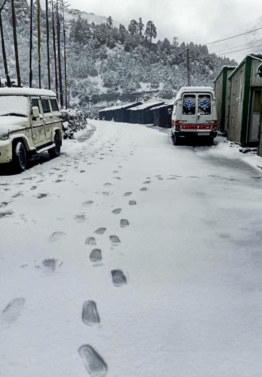 Vehicles lie covered in snow at Nathula, in East Sikkim district