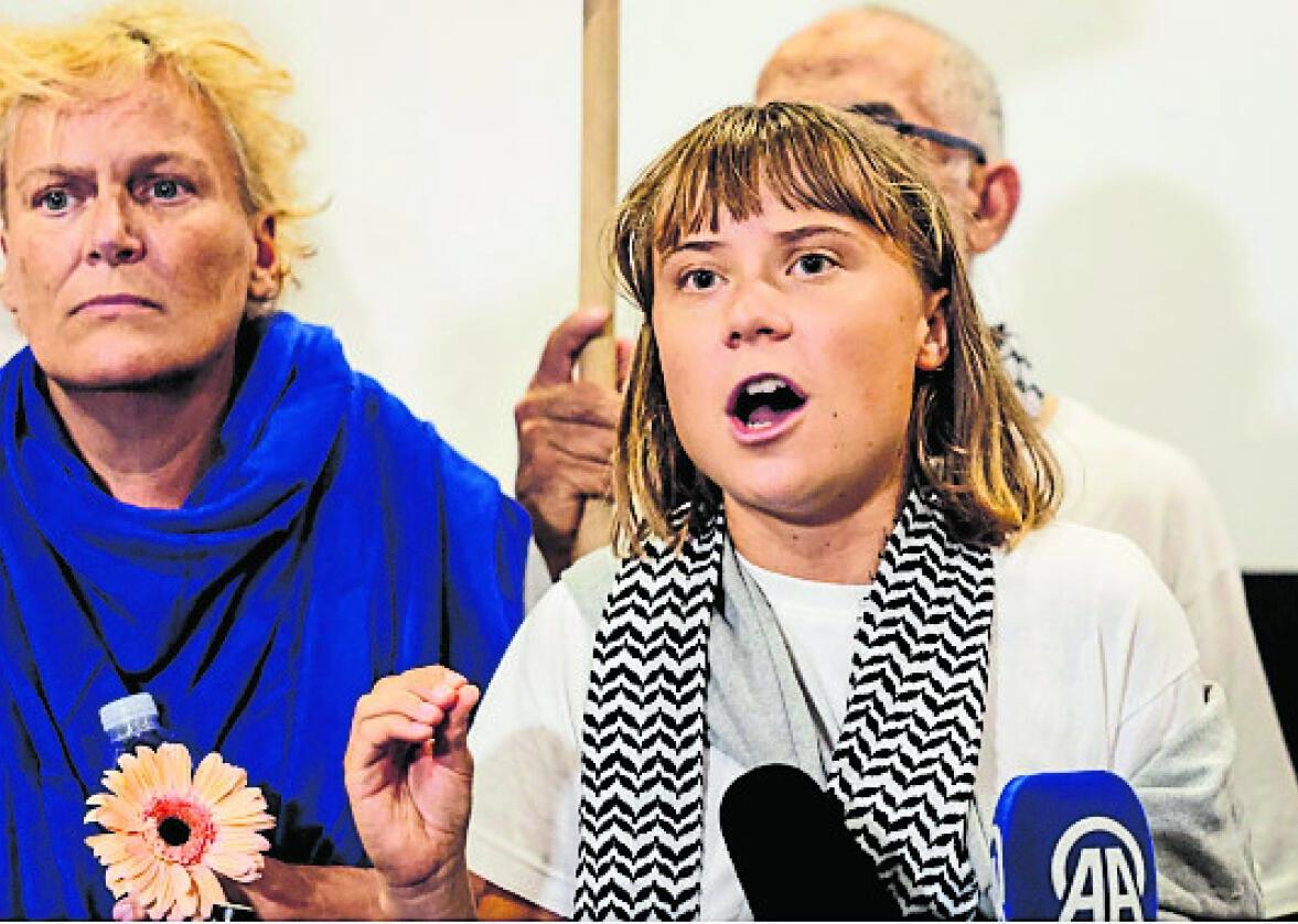 Swedish activist Greta Thunberg, who was detained for being part of the Global Sumud Flotilla to deliver aid to Gaza, delivers a statement at the Athens Airport in Greece on Monday. She was deported by Israel along with other activists. 