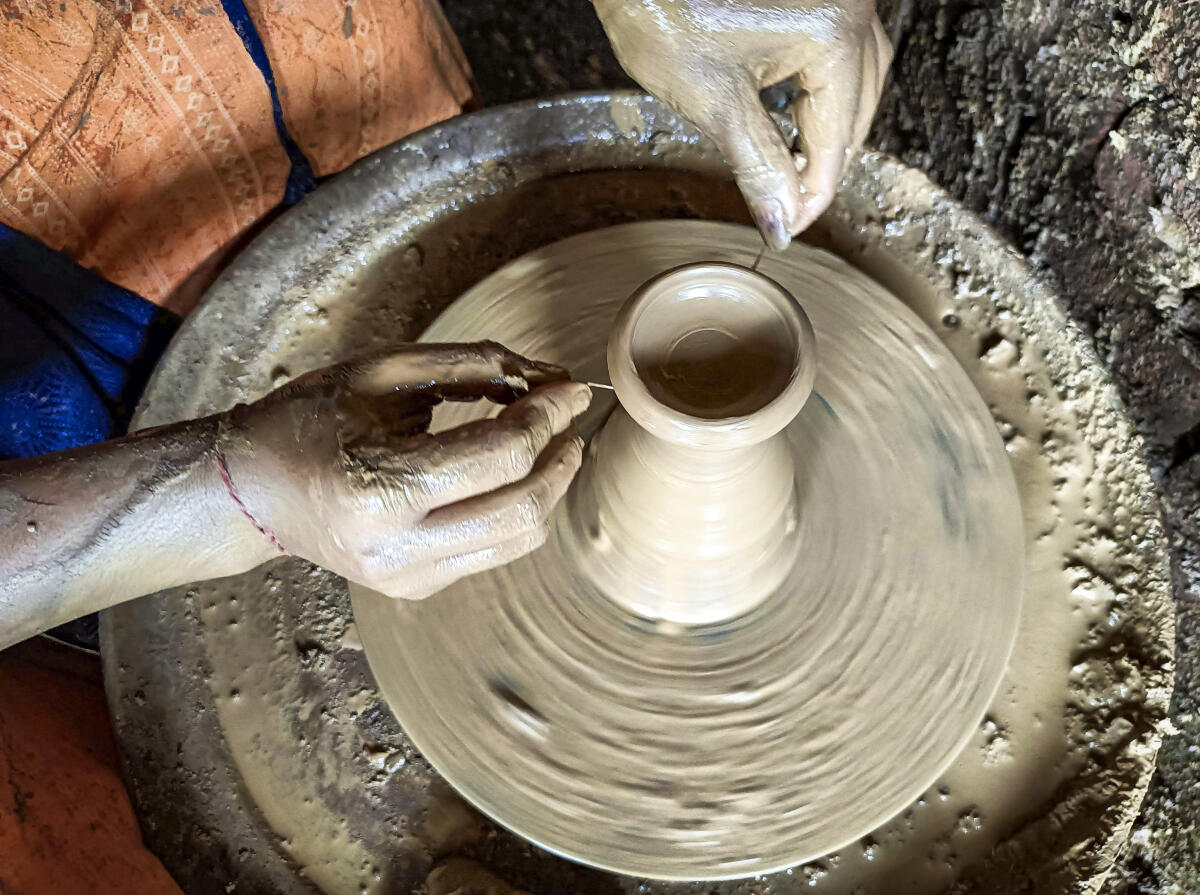 A potter makes an earthen lamp at a workshop ahead of ‘Diwali’ festival, in Bastar, Chhattisgarh