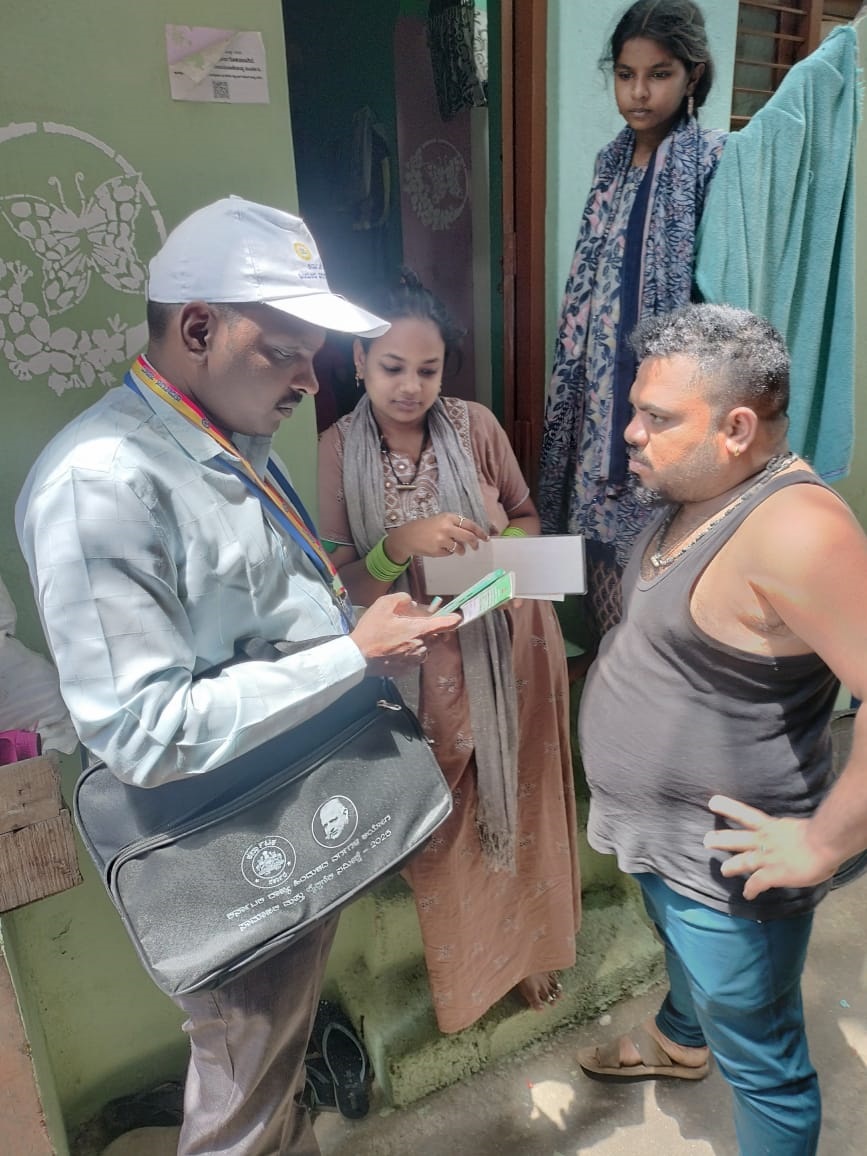 An enumerator seeks details from a resident of Subhash Nagar near Srirampura on Tuesday. SPECIAL ARRANGEMENT
