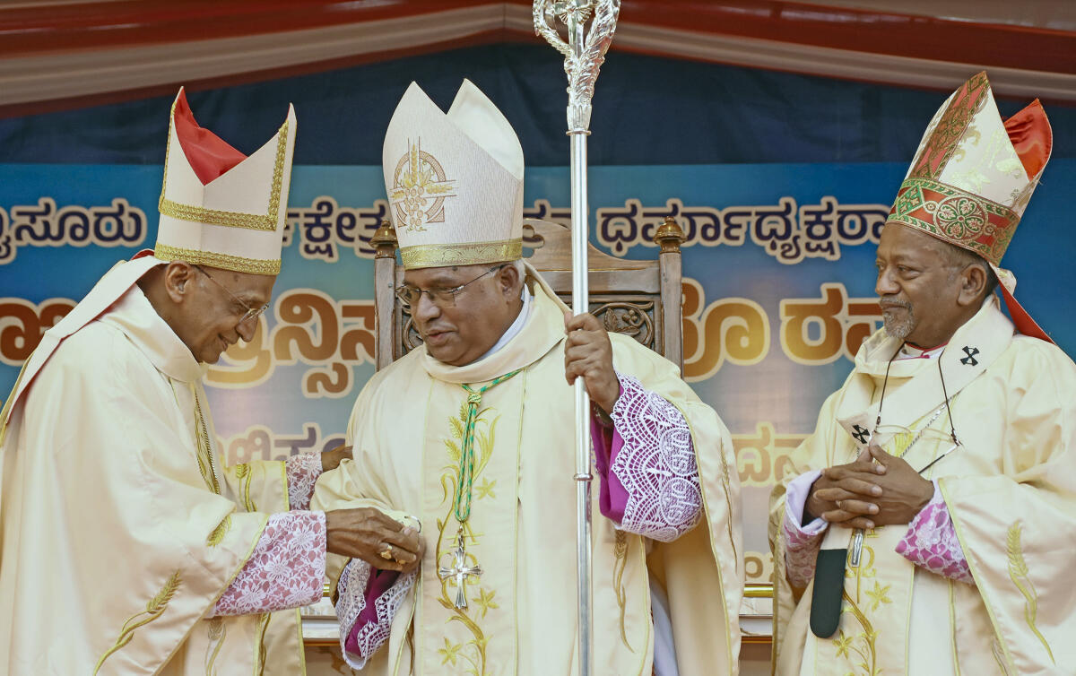 Francis Serrao, the newly appointed Bishop of Mysore, center, being officiated by the Archbishop of Bangalore Peter Machado, right, and others during his installation ceremony at St. Joseph’s Cathedral, also known as St. Philomena’s Church, in Mysuru, Karnataka.
