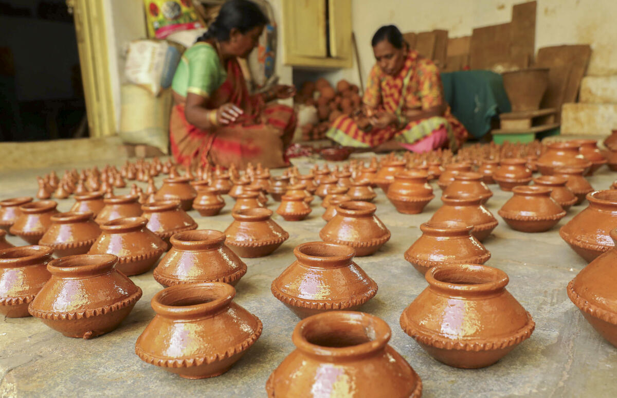 Artisans prepare earthenware amid preparations for the upcoming ‘Diwali’ festival, at Asif Nagar potters area, in Hyderabad.