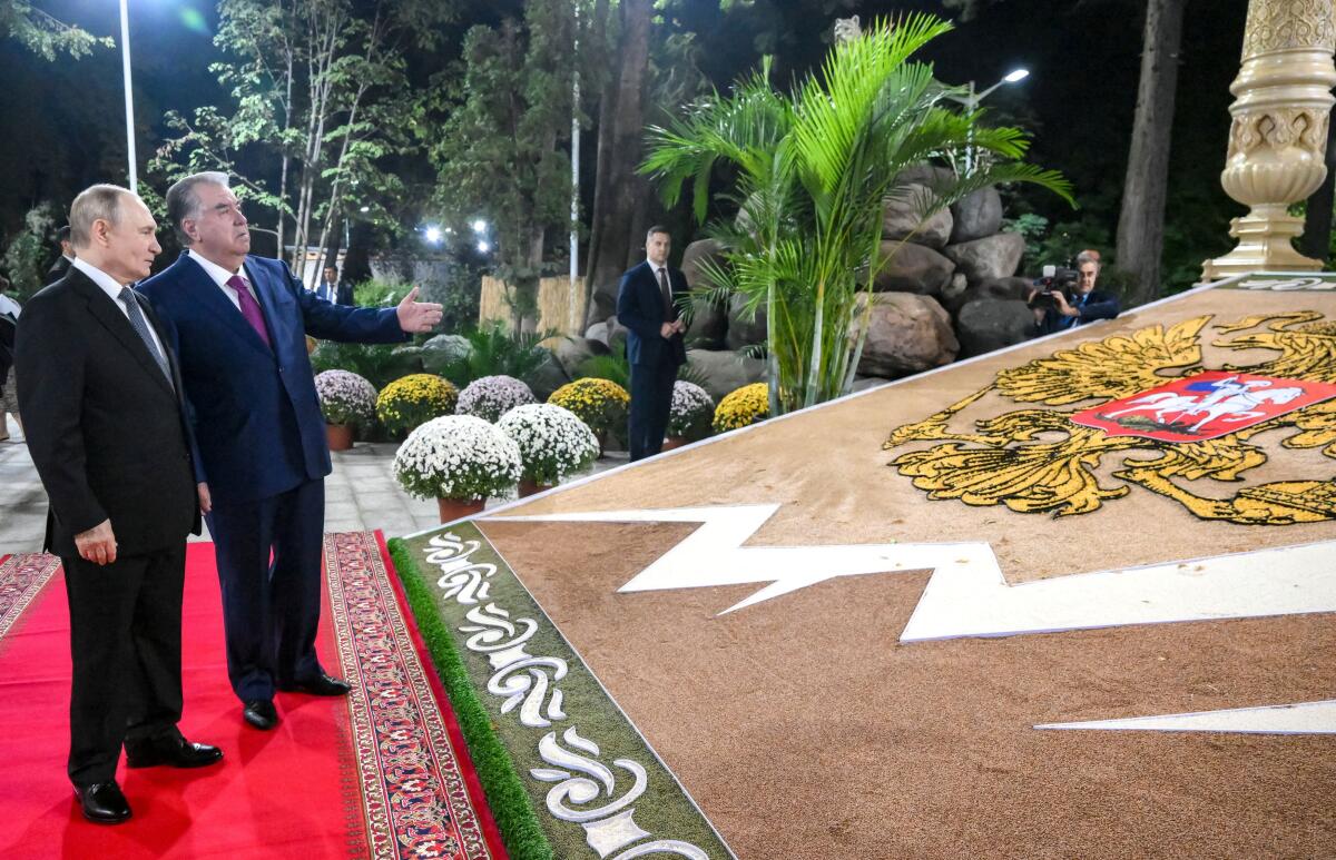 Russian President Vladimir Putin and Tajik President Emomali Rahmon arrive to attend an informal dinner at the Iram Botanical Garden in Dushanbe, Tajikistan.