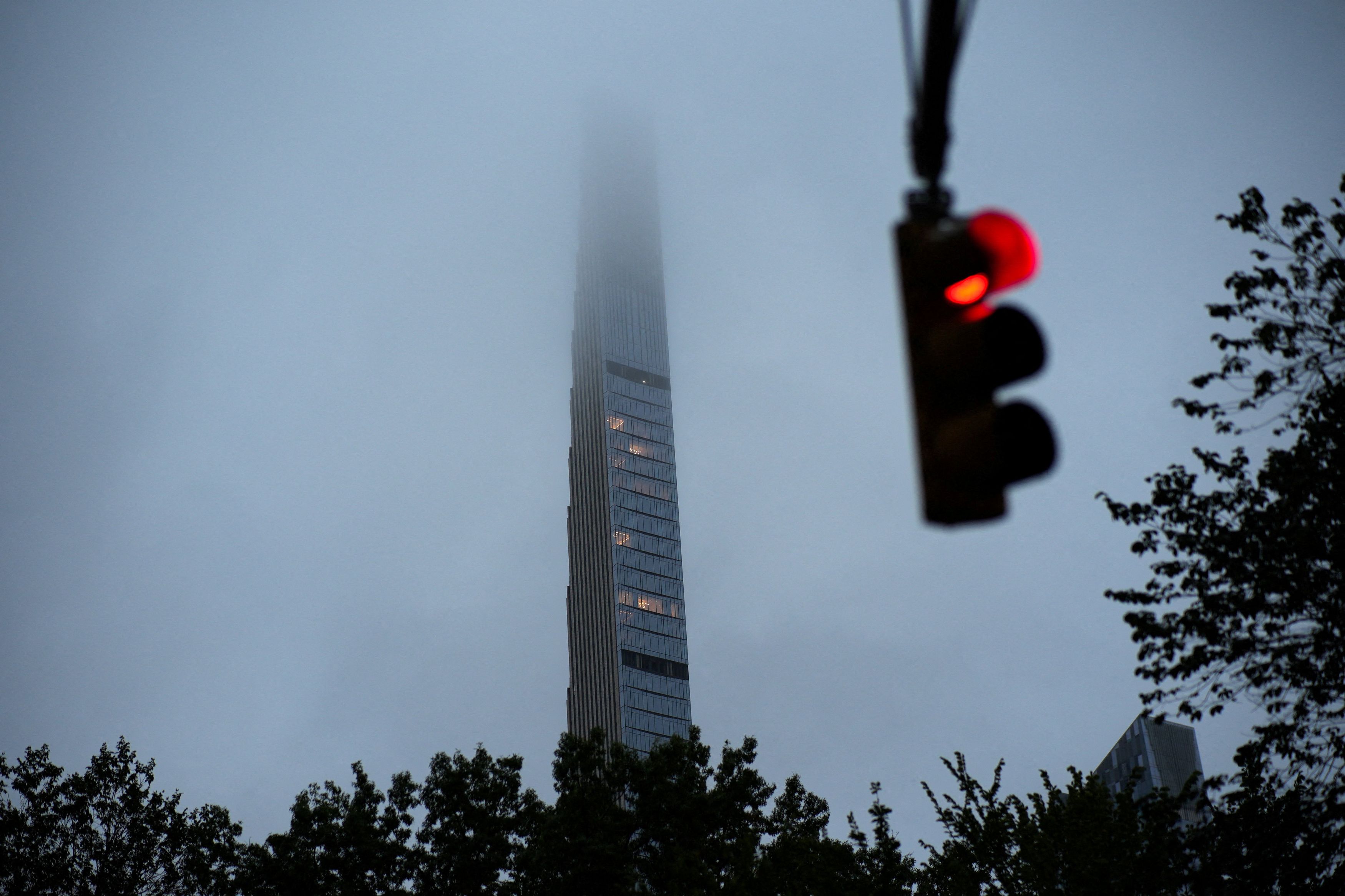 Clouds partially obscure the top of 111 West 57th Street, also known as Steinway Tower, in New York City