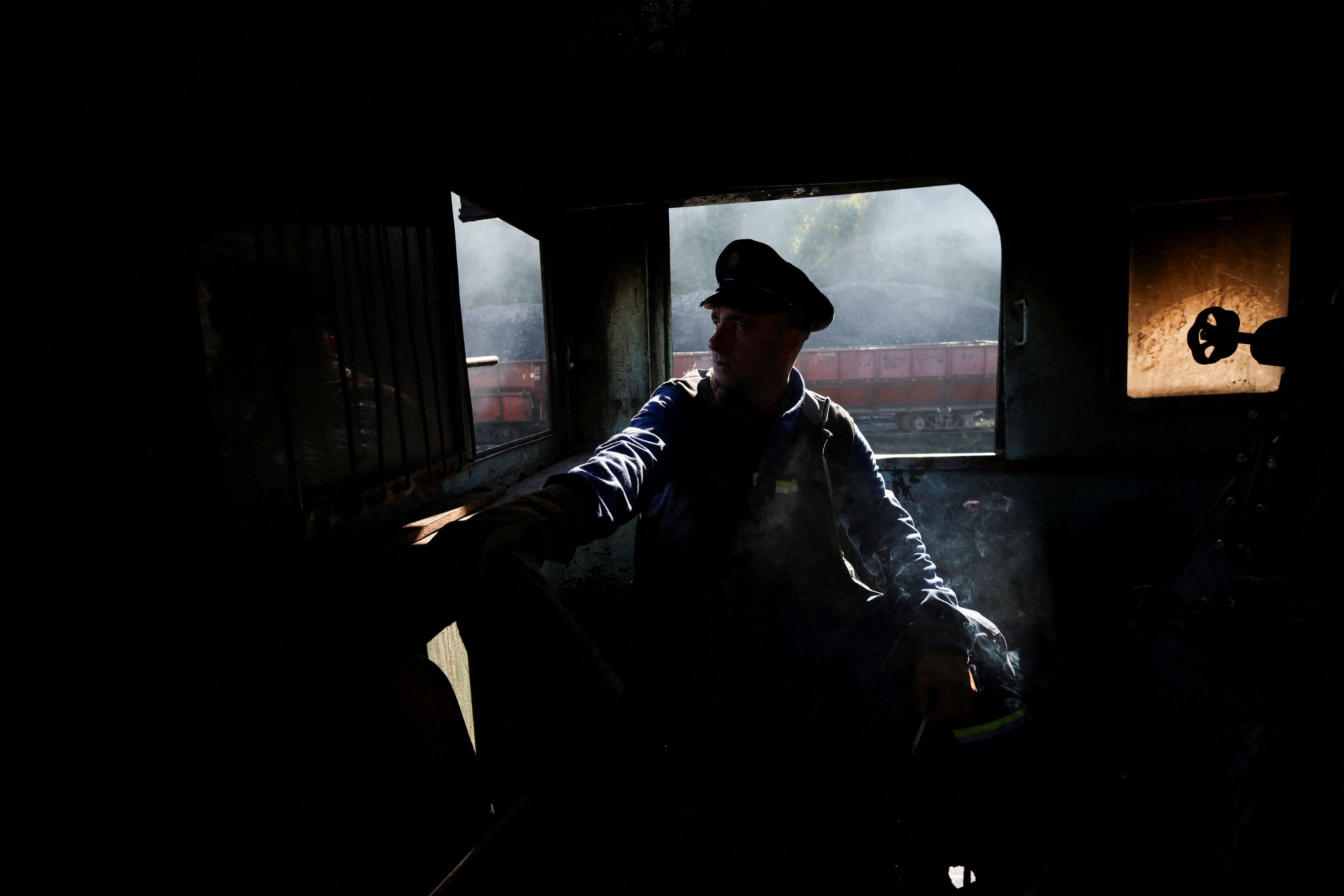 A train driver operates a steam locomotive in the Banovici mine, Bosnia and Herzegovina