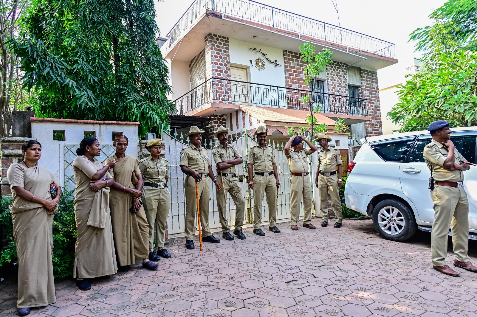 Police personnel deployed outside former MLA and BJP leader Subhas Guttedar's house during inspection from SIT sleuths in Kalaburagi on Friday.