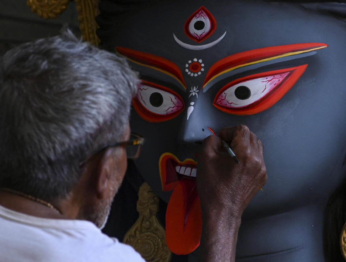 An artist gives final touches to an idol of Goddess Kali ahead of ‘Kali Puja’ festival, at Kumartuli, in Kolkata.