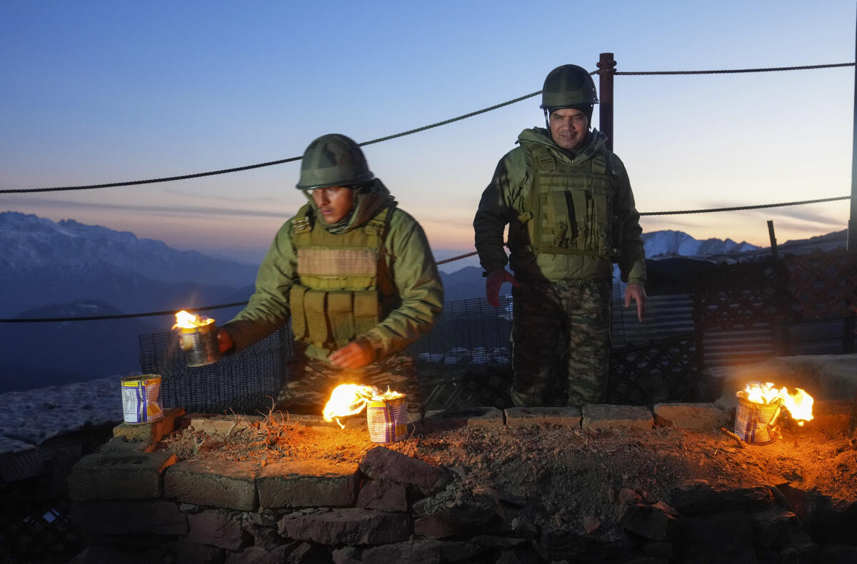 A soldier lights makeshift lamps during Diwali festival celebrations at a forward post along the Line of Control (LoC), in Kupwara district of north Kashmir.