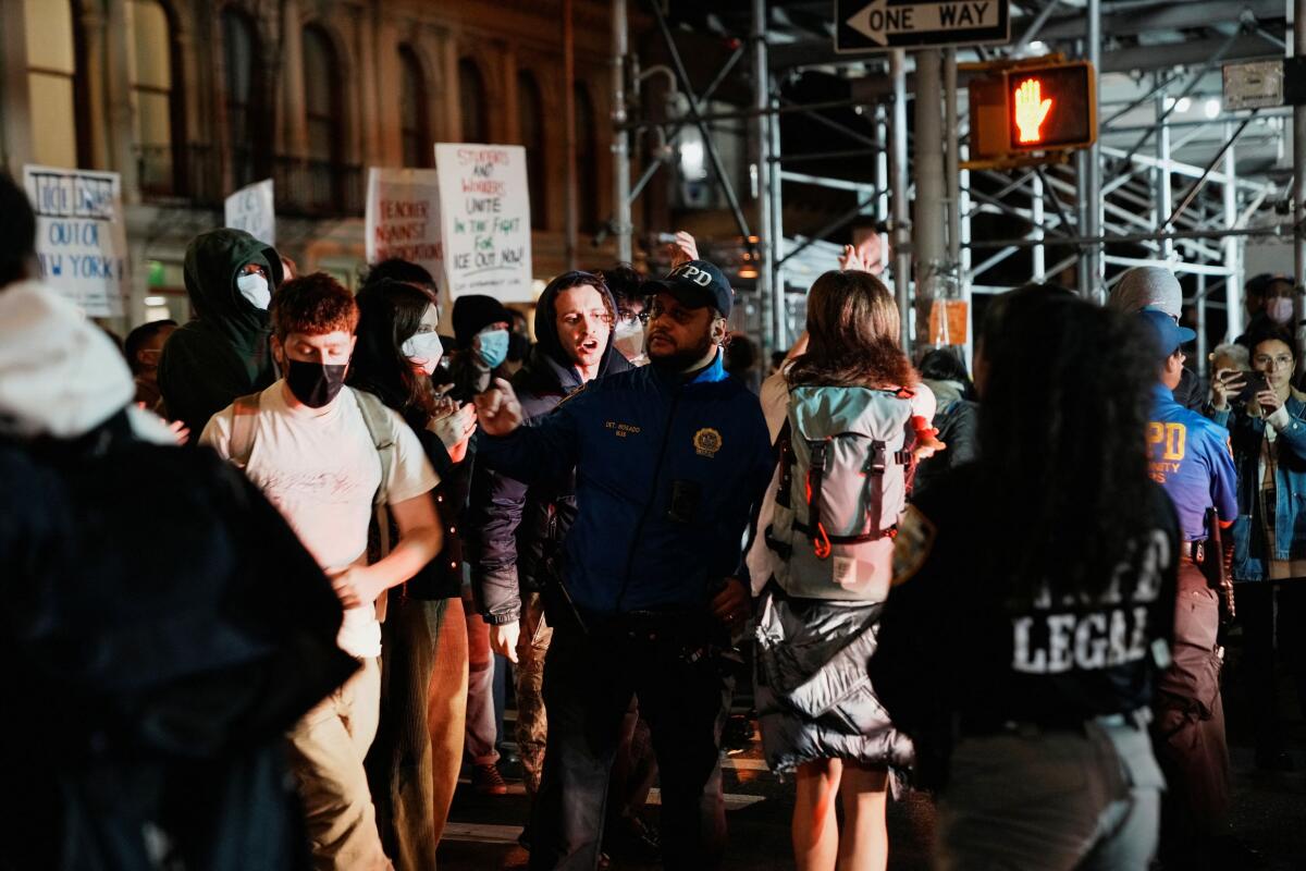 Police officers operate as people protest outside 26 Federal Plaza (Jacob K. Javits Federal Building) to demand the release of migrants who were detained during a raid in Lower Manhattan by U.S. Immigration and Customs Enforcement (ICE), in Manhattan, New York, US.