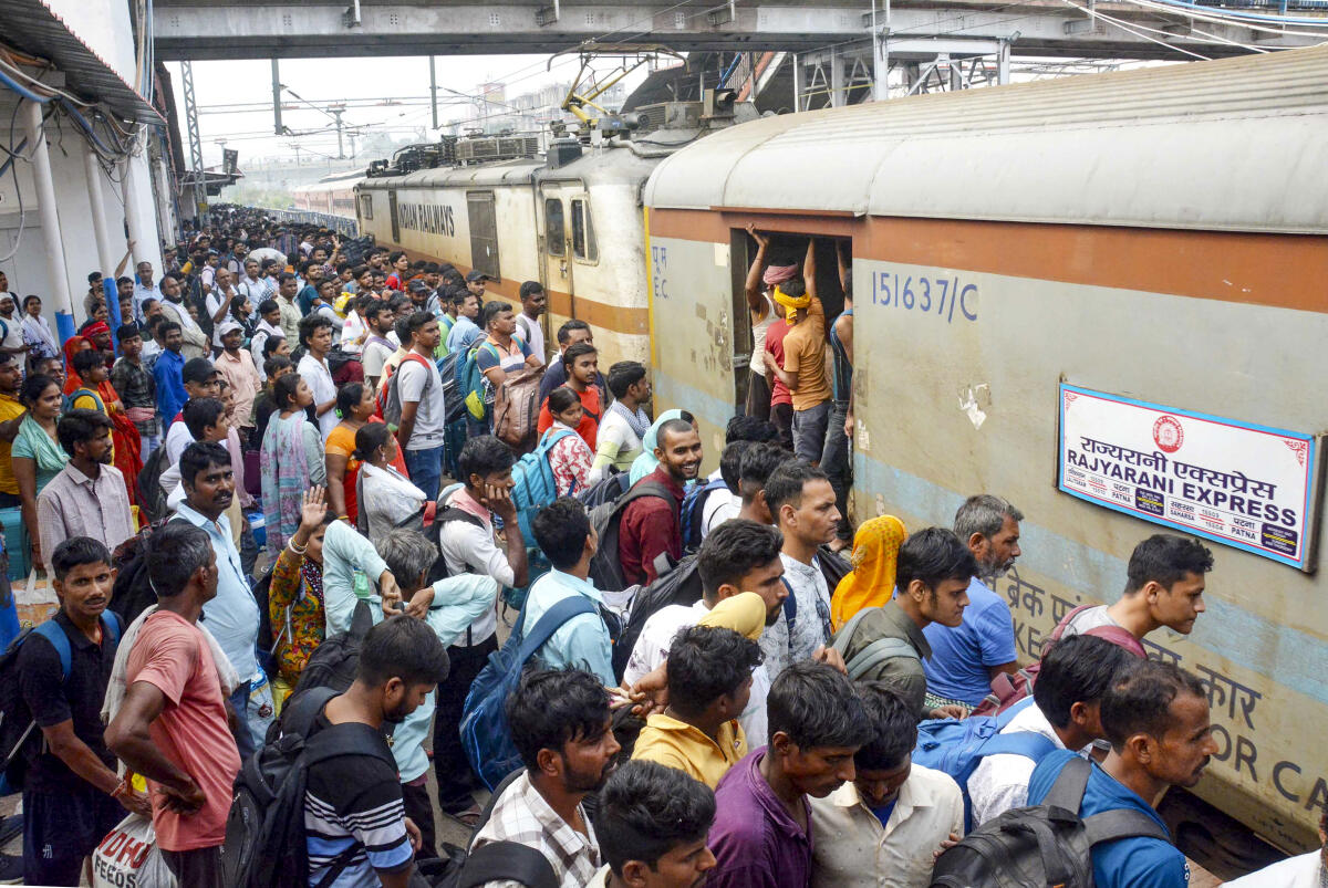 Passengers throng a platform amid heavy rush ahead of the Chhath Puja festival, at Patna Junction railway station, in Patna, Bihar.