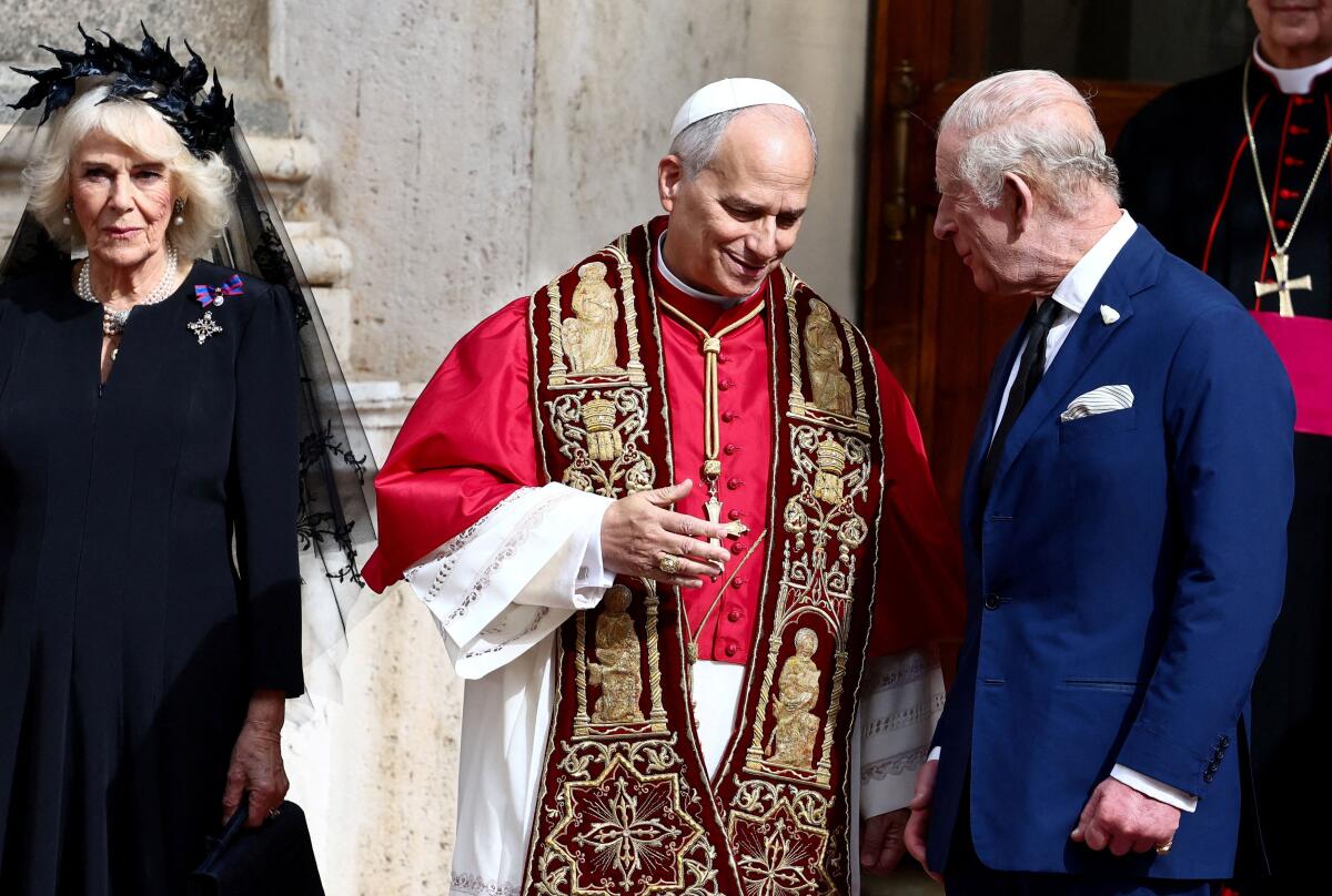 Britain's King Charles speaks with Pope Leo XIV in the courtyard of San Damaso, as Queen Camilla stands next to them, following an ecumenical prayer in the Sistine Chapelle led by the Pope and Archbishop of York Stephen Cottrell, at the Vatican.