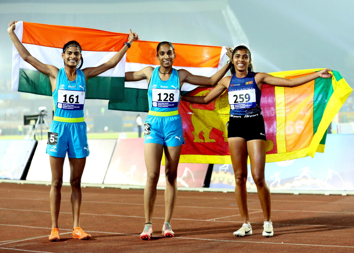India’s Amandeep Kaur, center, and compatriot Thota Sankeertana with Sri Lanka’s Kodithuwakku Takshi after winning in the women’s 800m final event during the 4th South Asian (SAAF) Senior Athletics Championships, at the Birsa Munda Athletics Stadium, in Ranchi, Jharkhand.