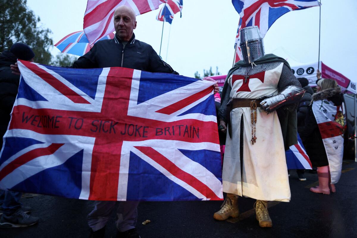 A demonstrator wears a Knights Templar costume during a protest near The Bell Hotel, following the mistaken release of Hadush Gerberslasie Kebatu, an Ethiopian asylum seeker convicted of sexually assaulting a teenage girl and a woman, who was re-arrested in north London this morning, in Epping, Essex, Britain.