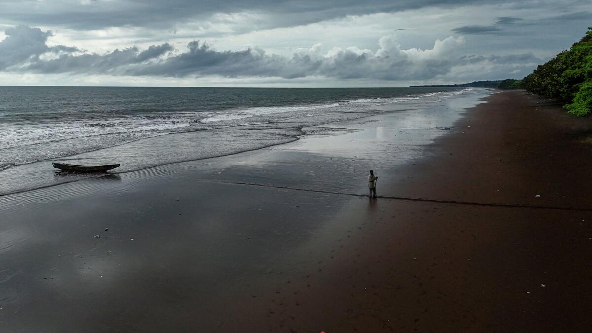 A drone view shows a fisherman getting ready to head out to the sea in Batoke near Limbe, Cameroon