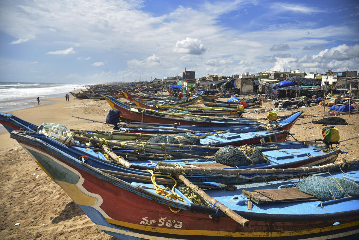 Boats parked on a beach as a precautionary measure against Cyclone 'Montha', in Puri
