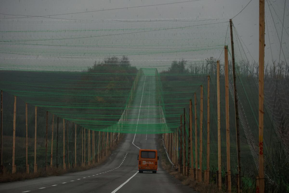 A car drives along a road covered with an anti-drone net, amid Russia's attack on Ukraine, near the town of Sloviansk in Donetsk region, Ukraine