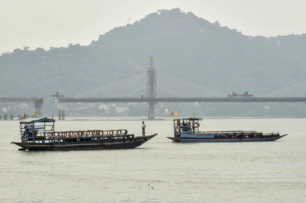 Ferry boats ply the waters of the Brahmaputra river, in Guwahati