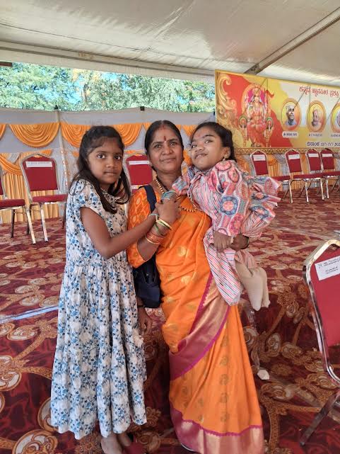 Specially abled Rachana Nagaraj being carried by her mother, sister Ananya joins. 