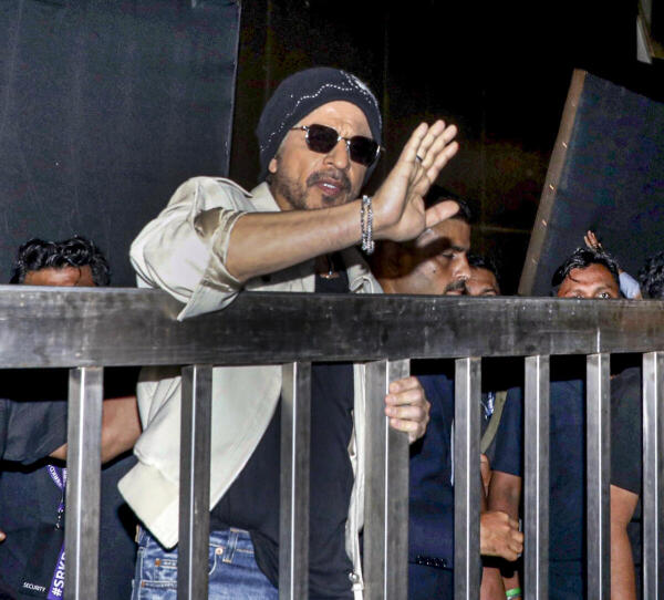 Bollywood actor Shah Rukh Khan greets fans on the occasion of his 60th birthday outside his residence, in Mumbai.