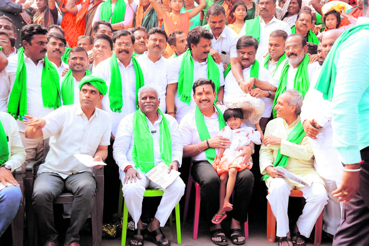 BJP state president B Y Vijayendra celebrates his birthday at the protest site on Wednesday morning. BJP Rajya Sabha member Iranna Kadadi and party spokesperson Rajeev Kudachi are seen. Vijayendra expressed his solidarity with the protest by staying overnight with the farmers.