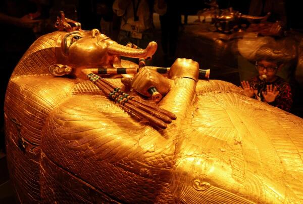 A child looks at the golden coffin of ancient Egyptian Pharaoh Tutankhamun during the first day for visitors after the official opening of the Grand Egyptian Museum (GEM), near the Giza pyramid complex, in Giza, Egypt.