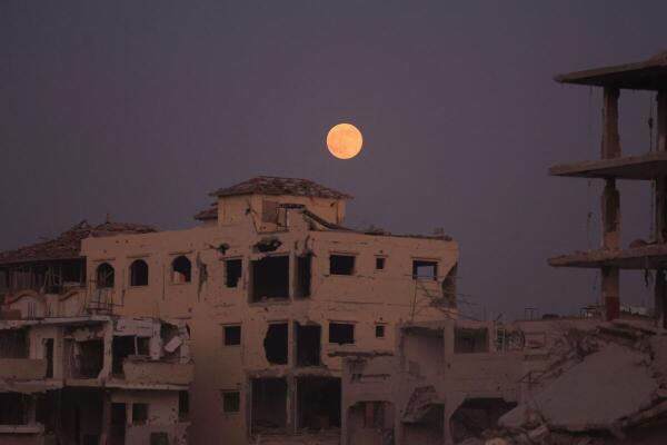 The Beaver Moon supermoon rises above destroyed buildings amid a ceasefire between Israel and Hamas, in Gaza City.
