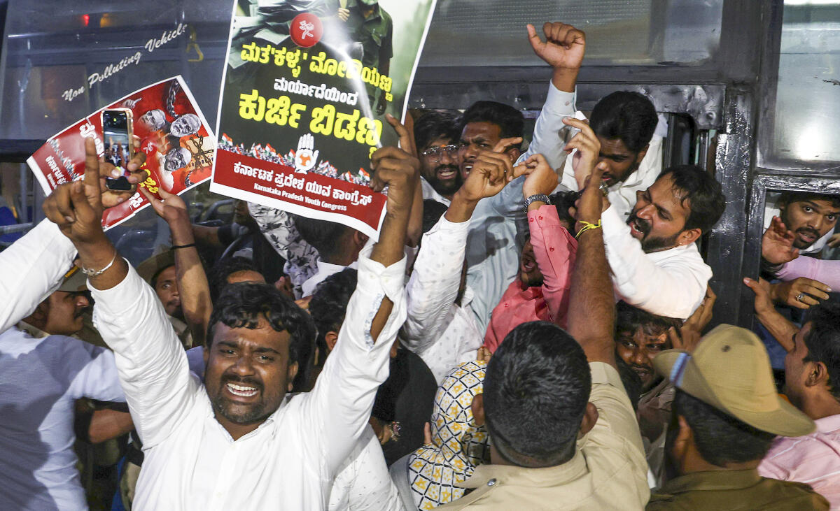 Police personnel detain Congress supporters during a protest over 'vote chori', in Bengaluru. Credit: PTI
