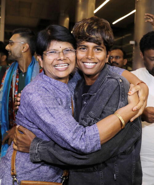 Women’s Indian Cricket World Cup-winning player Arundhati Reddy poses with her mother upon arrival at Rajiv Gandhi International Airport, in Hyderabad. Credit: PTI