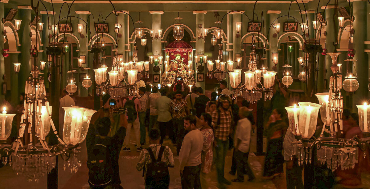People visit the Din Dayal Babur Thakur Bari temple illuminated with candles, at Shantipur, in Nadia district, West Bengal. Credit: PTI