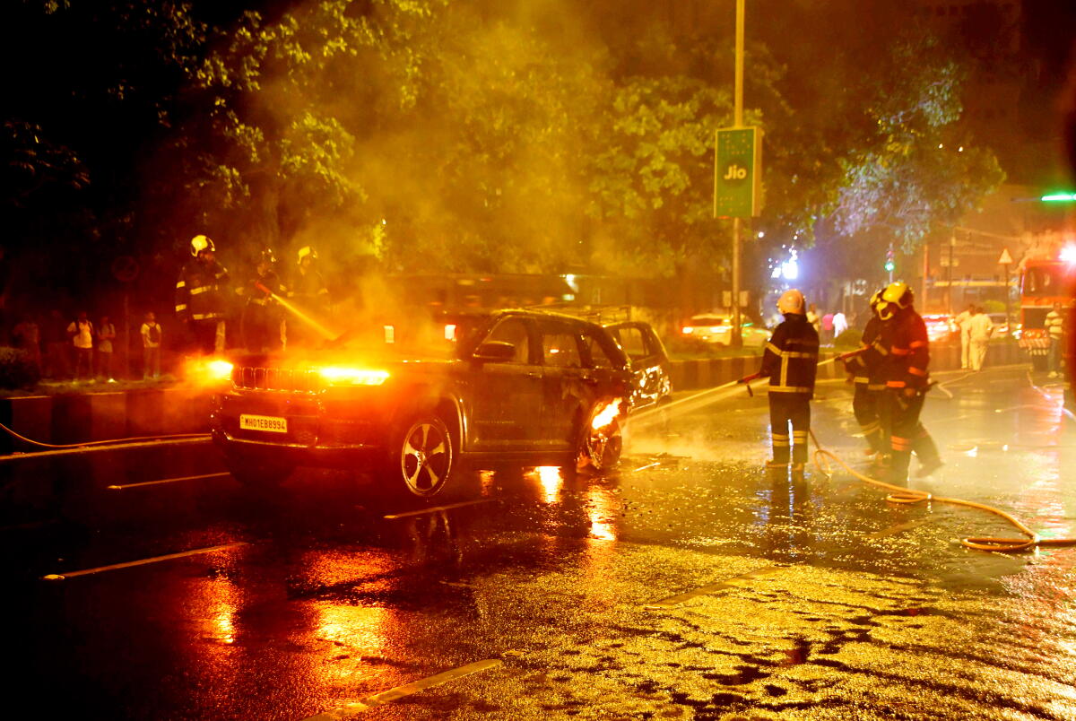 Firefighters douse the flames after two cars caught fire after a collision, near Marine Drive, in Mumbai. Credit: PTI