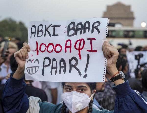 A demonstrator holds a placard during a protest over the deteriorating air quality in the national capital region, in New Delhi. Credit: PTI