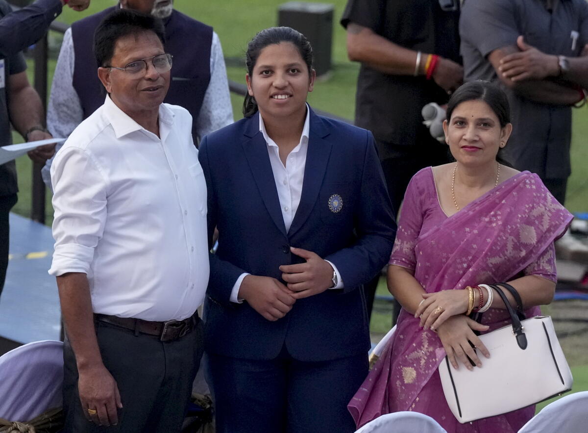 Richa Ghosh, member of the Women's ODI World Cup 2025-winning Indian cricket team, with her parents during a felicitation ceremony, in Kolkata. Credit: PTI