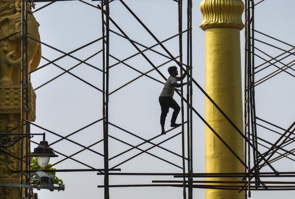 A worker prepares the gate of Chaityabhoomi as part of preparations for 'Mahaparinirvan Diwas', observed annually to commemorate the death anniversary of B.R. Ambedkar, at Dadar in Mumbai. Credit: PTI