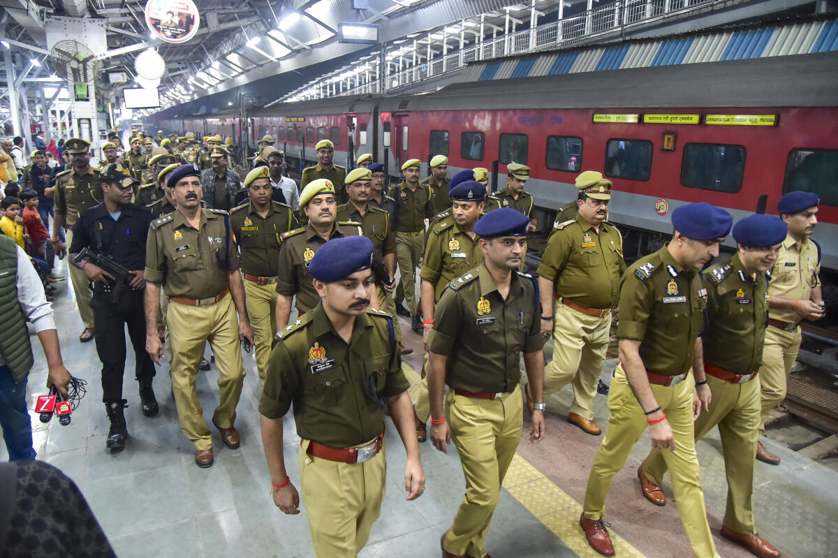 Police personnel conduct a search operation at Prayagraj Junction after security was beefed up following a blast near the Red Fort, in Prayagraj.