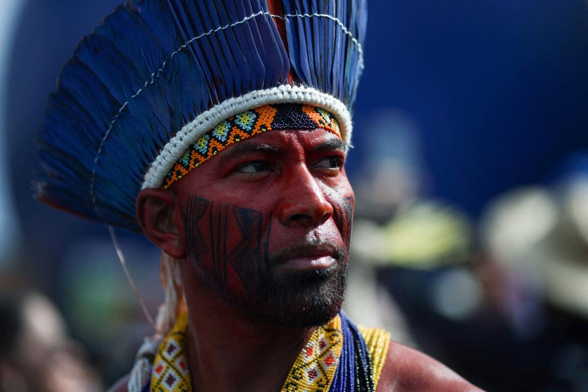 An indigenous man attends a protest to call for climate justice and territorial protection during the U.N. Climate Change Conference (COP30), in Belem, Brazil.