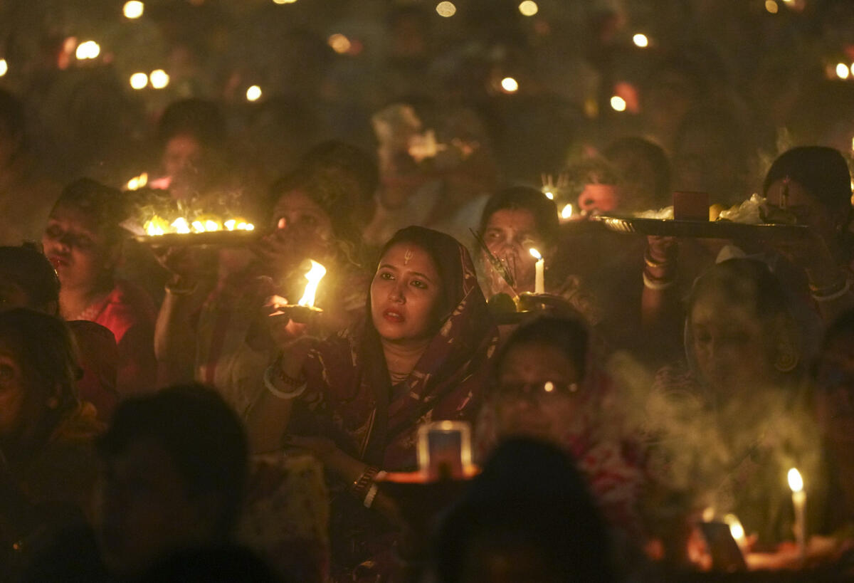 People perform 'puja' during the month of 'Kartik' as part of 'Rakher Upobash', a centuries-old tradition of devotion and fasting at the birthplace of Trikaldarshi Baba Loknath.
