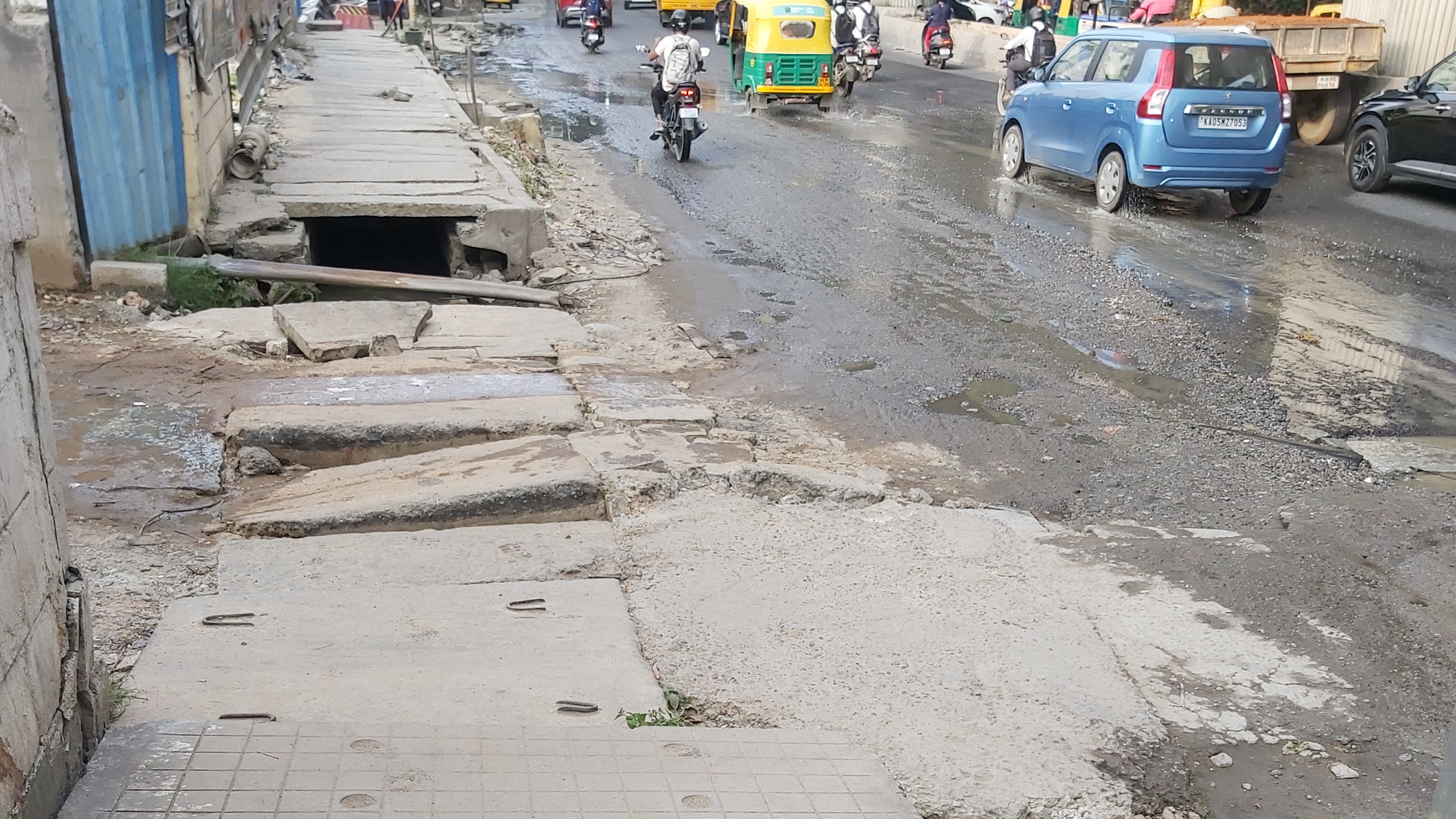 Broken footpaths on Bannerghatta Road forces pedestrians to walk on busy stretches   