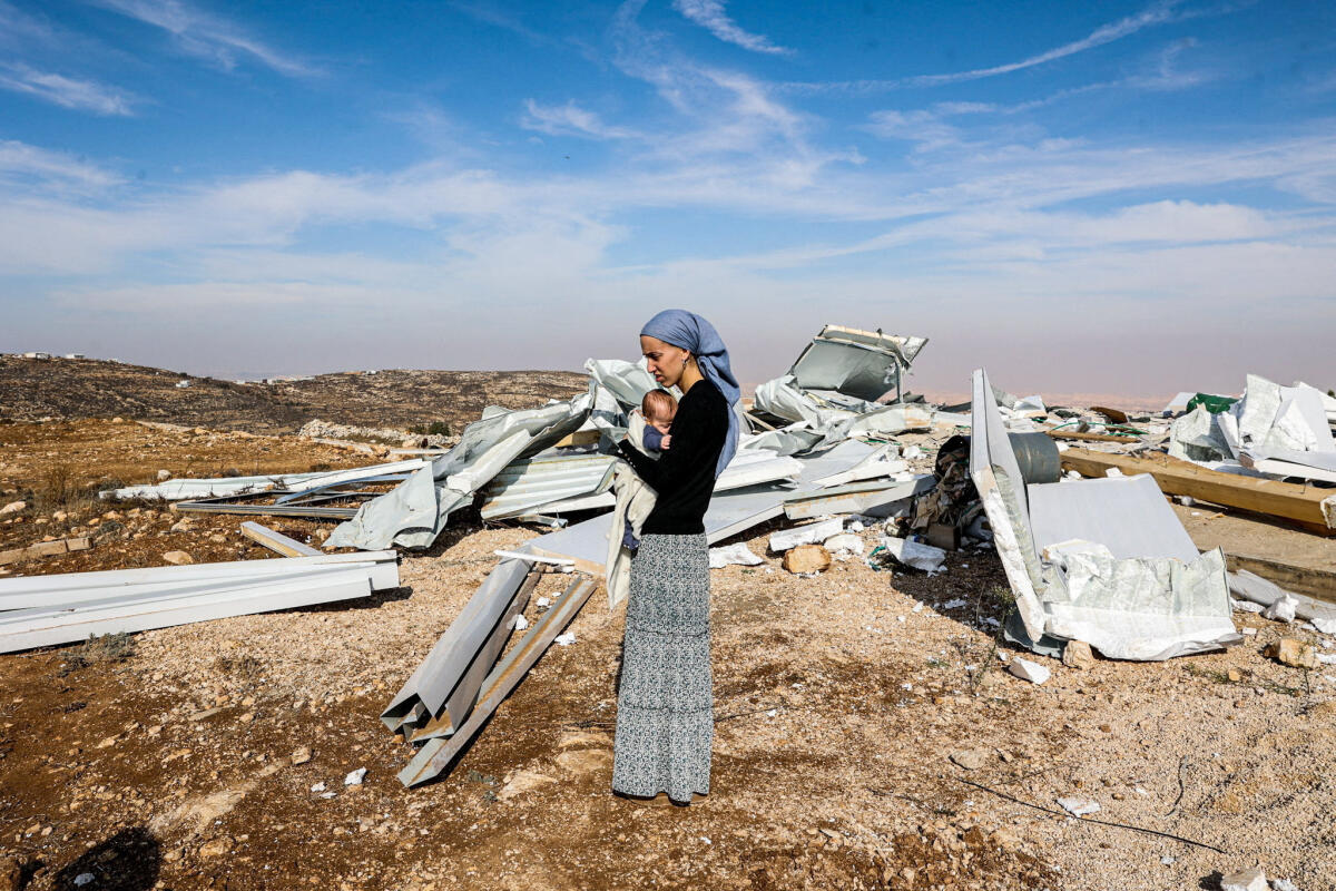 Achinoam holds her baby after her house was destroyed as Tzur Misgavi, an unauthorised Israeli settler outpost, is dismantled by Israeli security forces, in the Israeli-occupied West Bank.