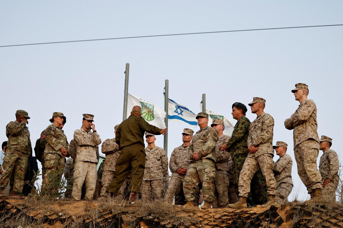 Senior military commanders and officers from around the world observe Gaza from Israel as part of an international seminar hosted by the Israeli military to share lessons from the last two years of its war, in Sderot, Israel.