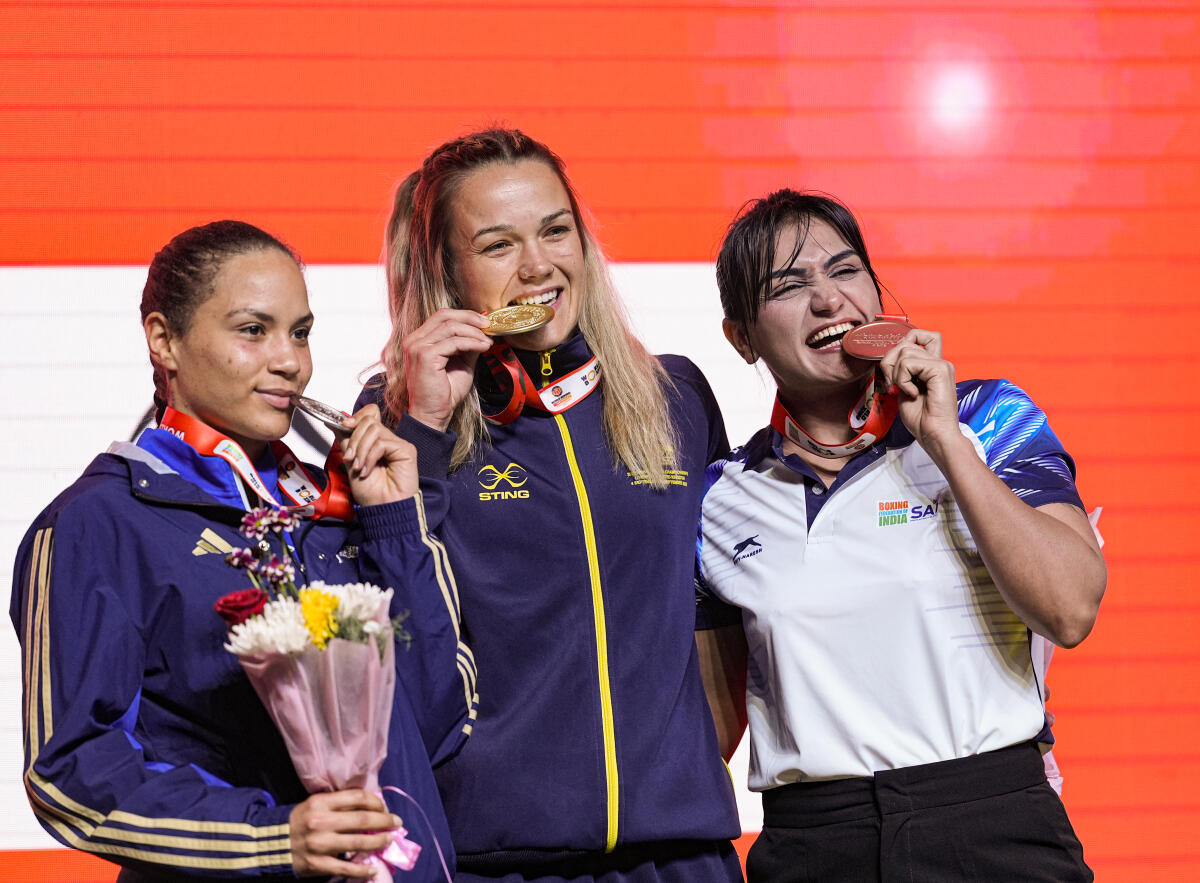 Gold medallist Australia's Emma-Sue Greentree, centre, with silver medallist Italy's Melissa Gemini, left, and bronze medallist India's Saweety during the felicitation ceremony after the women's 75kg final match at the World Boxing Cup Finals 2025, in Greater Noida, Uttar Pradesh, Thursday, Nov. 20, 2025.
