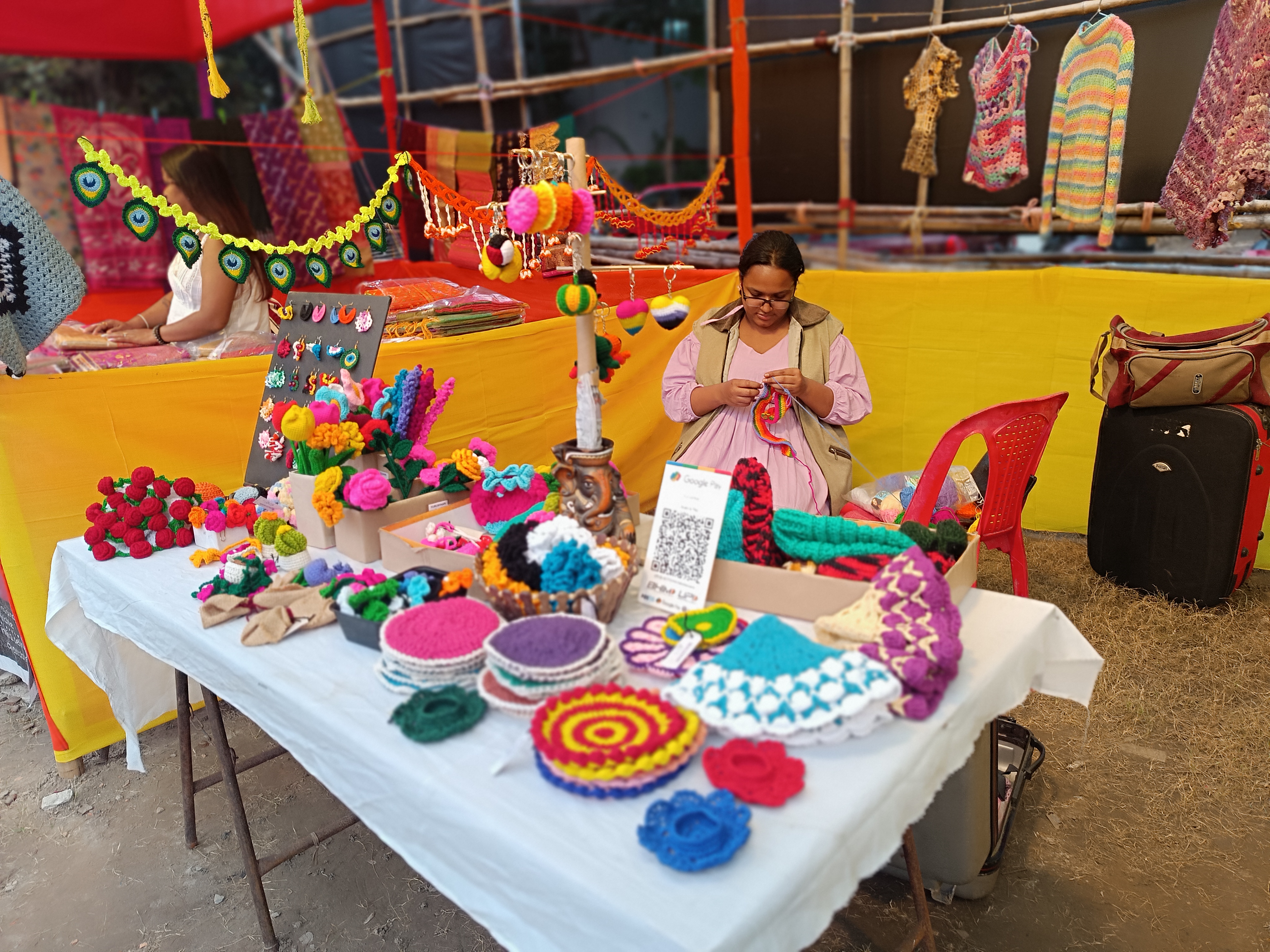 Animita from Chandannagar crochets while showcasing her products at the Rongdhonu Mela in Kolkata on Sunday, November 23. 