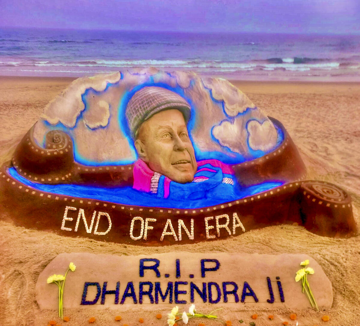 In this image posted on Nov. 24, 2025, sand artist Sudarsan Pattnaik creats a sand sculpture to pay tribute to veteran actor Dharmendra, who passed away on Monday, at Puri beach, Odisha.