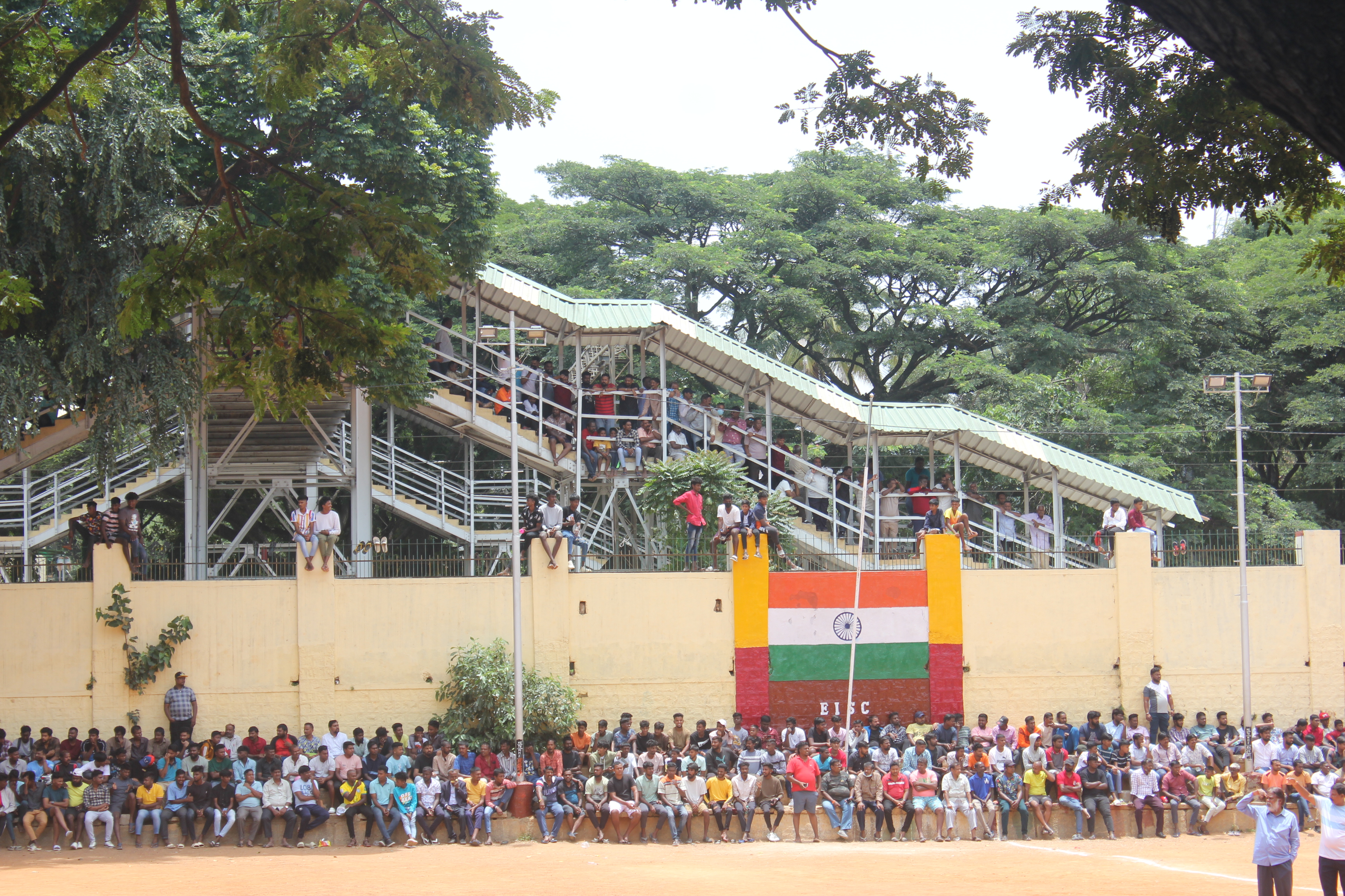 The crowd spills out from the stands to compound walls and stairs of a railway overbridge to watch the annual I-Day Cup tournament in Bengaluru